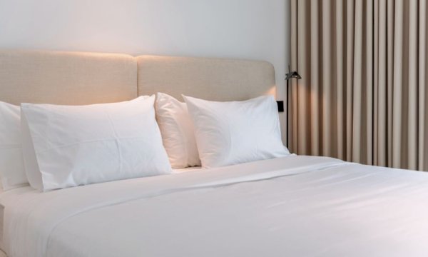 How does WooCommerce compare to dedicated hotel property management systems for small lodging businesses?